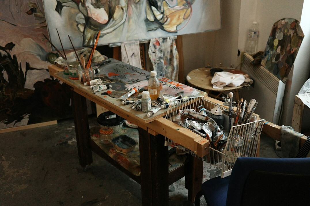 Open paint cans and brushes on a workbench